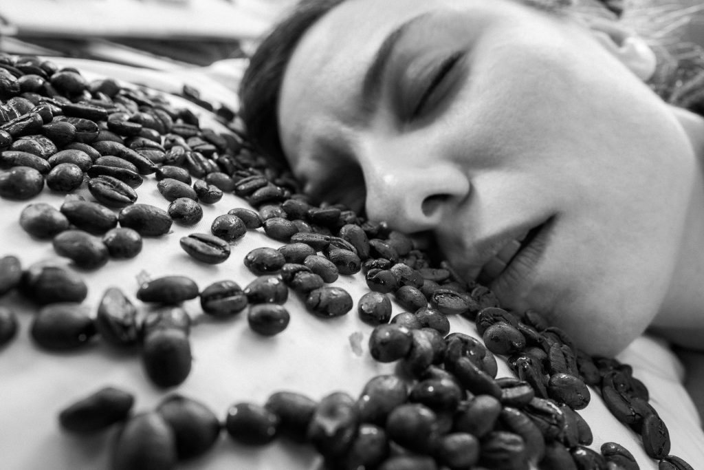 Woman sleeping on coffee beans
